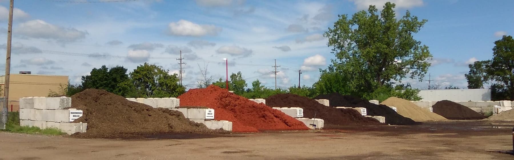Bulk mulch piles in a landscape supply yard
